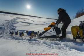 Katherine Keith runs down the bank onto the Koyukuk River after leaving the Huslia checkpoint on Saturday  March 14, 2015 during Iditarod 2015.  (C) Jeff Schultz/SchultzPhoto.com - ALL RIGHTS RESERVED DUPLICATION  PROHIBITED  WITHOUT  PERMISSION