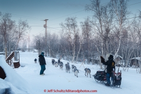 Hugh Neff waves goodbye to former Iditarod musher Jacques Philippe in the morning as he leaves the Huslia checkpoint on Saturday  March 14, 2015 during Iditarod 2015.  (C) Jeff Schultz/SchultzPhoto.com - ALL RIGHTS RESERVED DUPLICATION  PROHIBITED  WITHOUT  PERMISSION