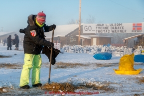 Teacher on the Trail Erin Montgomery helps other volunteers rake straw in the morning at the Huslia checkpoint on Saturday  March 14, 2015 during Iditarod 2015.  (C) Jeff Schultz/SchultzPhoto.com - ALL RIGHTS RESERVED DUPLICATION  PROHIBITED  WITHOUT  PERMISSION