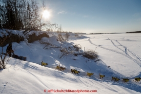 Mats Pettersson drops down the bank and onto the Koyukuk River after leaving the Huslia checkpoint on Saturday  March 14, 2015 during Iditarod 2015.  (C) Jeff Schultz/SchultzPhoto.com - ALL RIGHTS RESERVED DUPLICATION  PROHIBITED  WITHOUT  PERMISSION