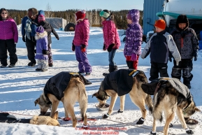 Youngsters watch Pete Kaiser dogs at the Elim checkpoint on Monday March 14th during the 2016 Iditarod.  Alaska    Photo by Jeff Schultz (C) 2016  ALL RIGHTS RESERVED
