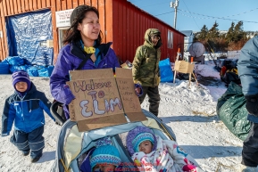 Local resident Sabrina Aukonn and her two daughters greet mushers at the Elim checkpoint on Monday March 14th during the 2016 Iditarod.  Alaska    Photo by Jeff Schultz (C) 2016  ALL RIGHTS RESERVED