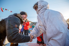 Second place finisher Dallas Seavey (left) congratulates 3rd place finisher Nicholas Petit at the finish line in Nome during the 2017 Iditarod on Tuesday eveing March 14, 2017.Photo by Jeff Schultz/SchultzPhoto.com  (C) 2017  ALL RIGHTS RESERVED