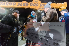 Joar Leifseth Ulsom recieves his winner's check from Kurt Parkan of sponsor Donlin Gold at the finish line in Nome, Alaska early on Wednesday morning March 14th as he wins the 46th running of the 2018 Iditarod Sled Dog Race.  He finished in 9 days 12 hours 00 minutes and 00 secondsPhoto by Jeff Schultz/SchultzPhoto.com  (C) 2018  ALL RIGHTS RESERVED
