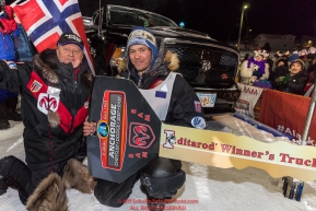 Joar Leifseth Ulsom recieves his Dodge Ram Winner's truck from Chuck Talskey of Anchorage Chrysler Dodge at the finish line in Nome, Alaska early on Wednesday morning March 14th as he wins the 46th running of the 2018 Iditarod Sled Dog Race.  He finished in 9 days 12 hours 00 minutes and 00 secondsPhoto by Jeff Schultz/SchultzPhoto.com  (C) 2018  ALL RIGHTS RESERVED