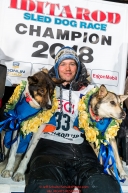Joar Leifseth Ulsom poses with his lead dogs Russeren (left) and Olive on the winner's podium at the finish line in Nome, Alaska early on Wednesday morning March 14th as he wins the 46th running of the 2018 Iditarod Sled Dog Race.  He finished in 9 days 12 hours 00 minutes and 00 secondsPhoto by Jeff Schultz/SchultzPhoto.com  (C) 2018  ALL RIGHTS RESERVED
