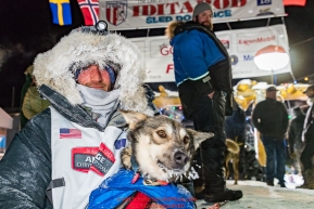 Nick Petit poses at the finish line in Nome, Alaska with his lead dog Libby early on Wednesday morning March 14th as places 2nd in the 46th running of the 2018 Iditarod Sled Dog Race.  Photo by Jeff Schultz/SchultzPhoto.com  (C) 2018  ALL RIGHTS RESERVED