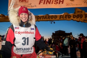 Aliy Zirkle poses at the finish line in Nome after completing the race in 15th place on Wednesday March 14th during the 2018 Iditarod Sled Dog Race.  Photo by Jeff Schultz/SchultzPhoto.com  (C) 2018  ALL RIGHTS RESERVED