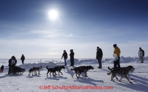 Thursday March 15, 2012  Rick Swenson runs past spectators up the bank from the Bering Sea into Nome.  Iditarod 2012.