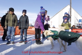 Thursday March 15, 2012  Young kids watch and pet Jim Lanier 's dogs at the finish line in Nome. Iditarod 2012.