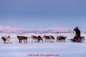 Aaron Burmeister runs on the slough with the Whaleback Mountains in the background leaving the Unalakleet  checkpoint at sunset on Sunday  March 15, 2015 during Iditarod 2015.  (C) Jeff Schultz/SchultzPhoto.com - ALL RIGHTS RESERVED DUPLICATION  PROHIBITED  WITHOUT  PERMISSION