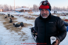 Scott Janssen warming up with some coffee at the Huslia checkpoint on the morning of Sunday  March 15, 2015 during Iditarod 2015.  (C) Jeff Schultz/SchultzPhoto.com - ALL RIGHTS RESERVED DUPLICATION  PROHIBITED  WITHOUT  PERMISSION