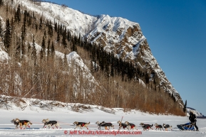 Kristy Berington runs past cliffs and Koyukuk Mountains just priort to the Koyukuk checkpoint on the afternoon of Sunday  March 15, 2015 during Iditarod 2015.  (C) Jeff Schultz/SchultzPhoto.com - ALL RIGHTS RESERVED DUPLICATION  PROHIBITED  WITHOUT  PERMISSION