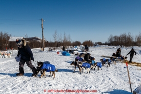 Volunteers help pull Jason Mackey to the trail as he leaves  the Koyukuk checkpoint on the afternoon of Sunday  March 15, 2015 during Iditarod 2015.  (C) Jeff Schultz/SchultzPhoto.com - ALL RIGHTS RESERVED DUPLICATION  PROHIBITED  WITHOUT  PERMISSION