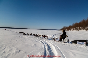 Lance Mackey runs down the bank of the Yukon River as he leaves the Koyukuk checkpoint on the afternoon of Sunday  March 15, 2015 during Iditarod 2015.  (C) Jeff Schultz/SchultzPhoto.com - ALL RIGHTS RESERVED DUPLICATION  PROHIBITED  WITHOUT  PERMISSION