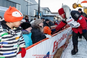 Aliy Zirkle greets the well-wishing crowd after her arrival at the finish line in Nome for a third place finish on Tuesday March 15th during the 2016 Iditarod.  Alaska    Photo by Jeff Schultz (C) 2016  ALL RIGHTS RESERVED