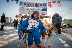 Wade Marrs with his leaders at the finish line in Nome after claiming 4th place on Tuesday March 15th during the 2016 Iditarod.  Alaska    Photo by Jeff Schultz (C) 2016  ALL RIGHTS RESERVED