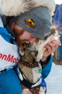 Wade Marrs gives one of his lead dogs a hug after finishing in 4th place at the finish line in Nome on Tuesday March 15th during the 2016 Iditarod.  Alaska    Photo by Jeff Schultz (C) 2016  ALL RIGHTS RESERVED