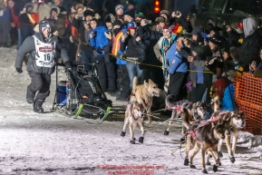 Dallas Seavey runs into the chute to win the 44th running of the Iditarod Sled Dog Race in Nome on Tuesday March 15th during the 2016 Iditarod in record time of 8 Days 11 hours 20 minutes 16 seconds Photo by Jeff Schultz (C) 2016  ALL RIGHTS RESERVED