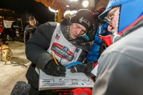 Dallas Seavey signs in after winning the 44th running of the Iditarod Sled Dog Race in Nome on Tuesday March 15th during the 2016 Iditarod in record time of 8 Days 11 hours 20 minutes 16 seconds Photo by Jeff Schultz (C) 2016  ALL RIGHTS RESERVED