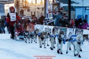 Aliy Zirkle runs into the finish chute as she arrives at the finish line in Nome for a third place finish on Tuesday March 15th during the 2016 Iditarod.  Alaska    Photo by Jeff Schultz (C) 2016  ALL RIGHTS RESERVED