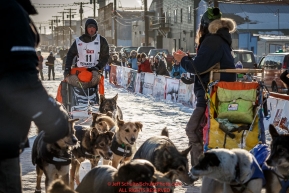 Pete Kaiser runs across the finish line to claim 5th place just minutes after Wade Marrs took 4th place in Nome on Tuesday March 15th during the 2016 Iditarod.  Alaska    Photo by Jeff Schultz (C) 2016  ALL RIGHTS RESERVED
