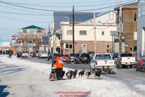 Pete Kaiser runs down Front Street in Nome with a police escort on his way to a 9th place finish during the 2017 Iditarod on Wednesday March 15, 2017.Photo by Jeff Schultz/SchultzPhoto.com  (C) 2017  ALL RIGHTS RESERVED