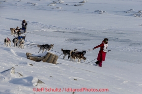 Lisbet Norris leads her team to the trail just outside Nome on  the Bering Sea with Marcelle Fressineau behind her on Saturday March 15 during the 2014 Iditarod Sled Dog Race.PHOTO (c) BY JEFF SCHULTZ/IditarodPhotos.com -- REPRODUCTION PROHIBITED WITHOUT PERMISSION