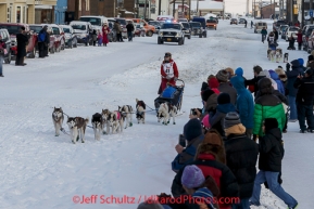 Lisbet Norris leads Marcelle Fressineau into the finish chute to claim 48th place at Nome on Saturday March 15 during the 2014 Iditarod Sled Dog Race.PHOTO (c) BY JEFF SCHULTZ/IditarodPhotos.com -- REPRODUCTION PROHIBITED WITHOUT PERMISSION