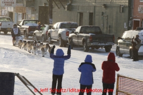 Russian musher Mikhail Telpin runs into the chute on Front Street in Nome to finish the Iditarod Sled Dog Race 2013Photo by Jeff Schultz copyright 2013 DO NOT REPRODUCE WITHOUT PERMISSION