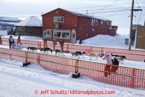 Russian musher Mikhail Telpin runs into the chute on Front Street in Nome to finish the Iditarod Sled Dog Race 2013Photo by Jeff Schultz copyright 2013 DO NOT REPRODUCE WITHOUT PERMISSION