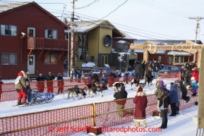 Russian musher Mikhail Telpin runs into the chute on Front Street in Nome to finish the Iditarod Sled Dog Race 2013Photo by Jeff Schultz copyright 2013 DO NOT REPRODUCE WITHOUT PERMISSION