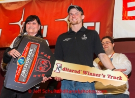 Dallas Seavey gets his key for his new Dodge RAM truck from Anchorage Chrysler Dodge at the musher 's finishers banquet in Nome on Sunday March 16 after the 2014 Iditarod Sled Dog Race.PHOTO (c) BY JEFF SCHULTZ/IditarodPhotos.com -- REPRODUCTION PROHIBITED WITHOUT PERMISSION