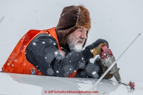 Volunteer pilot Greg Fischer fuels his plane during a snowfall at the Unalakleet checkpoint on Monday March 16, 2015 during Iditarod 2015.  (C) Jeff Schultz/SchultzPhoto.com - ALL RIGHTS RESERVED DUPLICATION  PROHIBITED  WITHOUT  PERMISSION