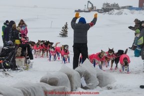 Race judge Andy Angstman holds his hands up to motion stop to DeeDee Jonrowe as she approaches the Unalakleet checkpoint in the evening on Monday March 16, 2015 during Iditarod 2015.  (C) Jeff Schultz/SchultzPhoto.com - ALL RIGHTS RESERVED DUPLICATION  PROHIBITED  WITHOUT  PERMISSION