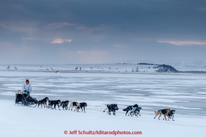 Martin Buser runs on the slough ice just before the Unalakleet checkpoint in the morning on Monday March 16, 2015 during Iditarod 2015.  (C) Jeff Schultz/SchultzPhoto.com - ALL RIGHTS RESERVED DUPLICATION  PROHIBITED  WITHOUT  PERMISSION