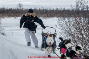 Christian Turner runs up a drifted in part of the trail several miles before the Unalakleet checkpoint on Monday March 16, 2015 during Iditarod 2015.  (C) Jeff Schultz/SchultzPhoto.com - ALL RIGHTS RESERVED DUPLICATION  PROHIBITED  WITHOUT  PERMISSION