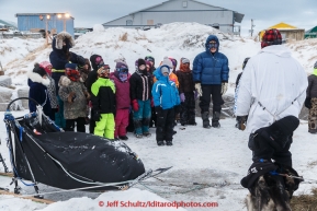 Martin Buser is greeted by a class of second graders from the Unalakleet school during his arrival the Unalakleet checkpoint in the morning on Monday March 16, 2015 during Iditarod 2015.  (C) Jeff Schultz/SchultzPhoto.com - ALL RIGHTS RESERVED DUPLICATION  PROHIBITED  WITHOUT  PERMISSION