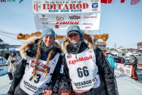 Kristy and Anna Berington pose at the finish line in Nome shorlty after finishing during the 2017 Iditarod on Thursday March 16, 2017.Photo by Jeff Schultz/SchultzPhoto.com  (C) 2017  ALL RIGHTS RESERVED