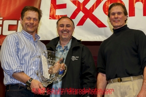 David Booker and Dr. Stuart Nelson DVM award the Alaska Airlines Leonhard Seppala Humanitarian Award to Martin Buser at the musher 's finishers banquet in Nome on Sunday March 16 after the 2014 Iditarod Sled Dog Race.PHOTO (c) BY JEFF SCHULTZ/IditarodPhotos.com -- REPRODUCTION PROHIBITED WITHOUT PERMISSION