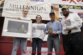 Mitch Seavey receives the Wells Fargo Gold Coast award for being the first musher to Unalakleet from Wells Fargo sponsor Tyler Hull, Martina Painter and Scott A Johnson at the musher awards banquet in Nome on Sunday March 17, 2013.  Iditarod Sled Dog Race 2013Photo by Jeff Schultz copyright 2013 DO NOT REPRODUCE WITHOUT PERMISSION