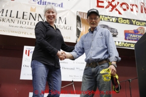 Mitch Seavey receives, on behalf of his lead dog