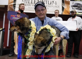 2013 Iditarod Champion Mitch Seavey poses with his lead dogs Taurus and Tanner on the stage at the musher awards banquet in Nome on Sunday March 17, 2013.  Iditarod Sled Dog Race 2013Photo by Jeff Schultz copyright 2013 DO NOT REPRODUCE WITHOUT PERMISSION