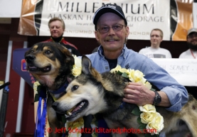 2013 Iditarod Champion Mitch Seavey poses with his lead dogs Taurus and Tanner on the stage at the musher awards banquet in Nome on Sunday March 17, 2013.  Iditarod Sled Dog Race 2013Photo by Jeff Schultz copyright 2013 DO NOT REPRODUCE WITHOUT PERMISSION