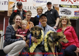 2013 Iditarod Champion Mitch Seavey poses with his lead dogs Taurus and Tanner and many from his family on the stage at the musher awards banquet in Nome on Sunday March 17, 2013.  Iditarod Sled Dog Race 2013Photo by Jeff Schultz copyright 2013 DO NOT REPRODUCE WITHOUT PERMISSION