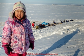 Young Savannah Paniptchuk watches the teams rest at the Shaktoolik checkpoint on Tuesday March 16, 2015 during Iditarod 2015.  (C) Jeff Schultz/SchultzPhoto.com - ALL RIGHTS RESERVED DUPLICATION  PROHIBITED  WITHOUT  PERMISSION