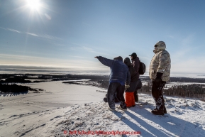 Tourists watch for Mitch Seavey from the hill at White Mountain over looking the Fish River at the White Mountain checkpoint on Tuesday March 16, 2015 during Iditarod 2015.  (C) Jeff Schultz/SchultzPhoto.com - ALL RIGHTS RESERVED DUPLICATION  PROHIBITED  WITHOUT  PERMISSION