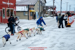 Gunnar Johnson gets help coming off of Front Street and into the finish chute in Nome  during the 2017 Iditarod on Friday March 17, 2017.Photo by Jeff Schultz/SchultzPhoto.com  (C) 2017  ALL RIGHTS RESERVED