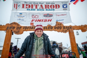 Nome Mayor Richard Beneville stands at the finish line in Nome to welcome several mushers during the 2017 Iditarod on Friday March 17, 2017.Photo by Jeff Schultz/SchultzPhoto.com  (C) 2017  ALL RIGHTS RESERVED