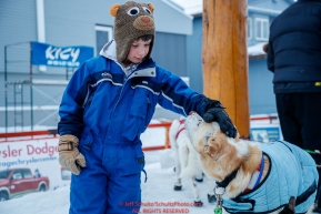 A young race fan pets a Gunna Johnson dog at the finish line in Nome  during the 2017 Iditarod on Friday March 17, 2017.Photo by Jeff Schultz/SchultzPhoto.com  (C) 2017  ALL RIGHTS RESERVED